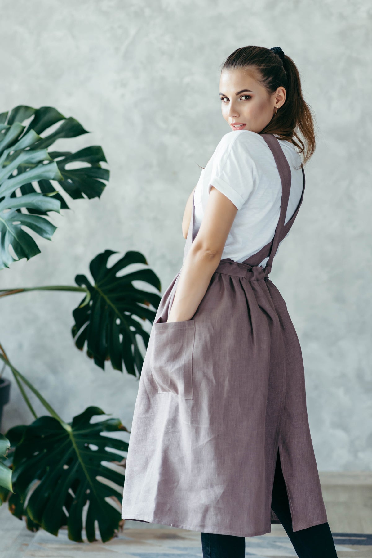 Linen pinafore apron worn by a maker