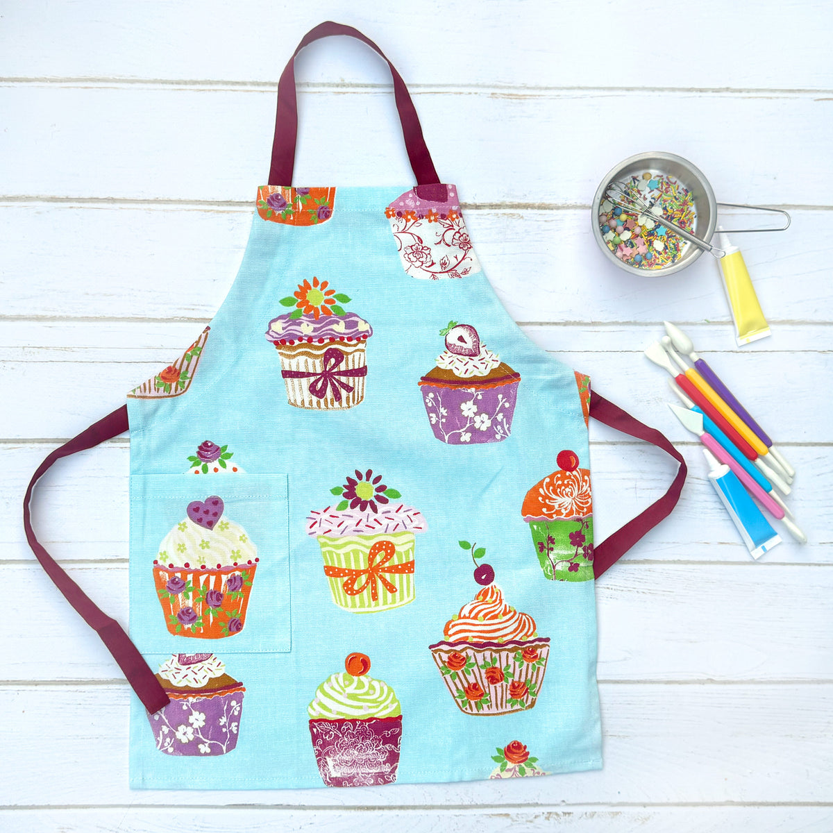Blue and pink cupcake print kids chef apron, front view