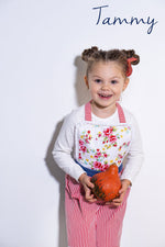 Toddler apron hanging on a play kitchen