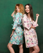 Two bridesmaids in printed crepe kimono robes, turquoise and beige