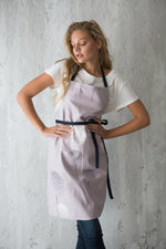 Lilac dandelion print apron worn in the kitchen