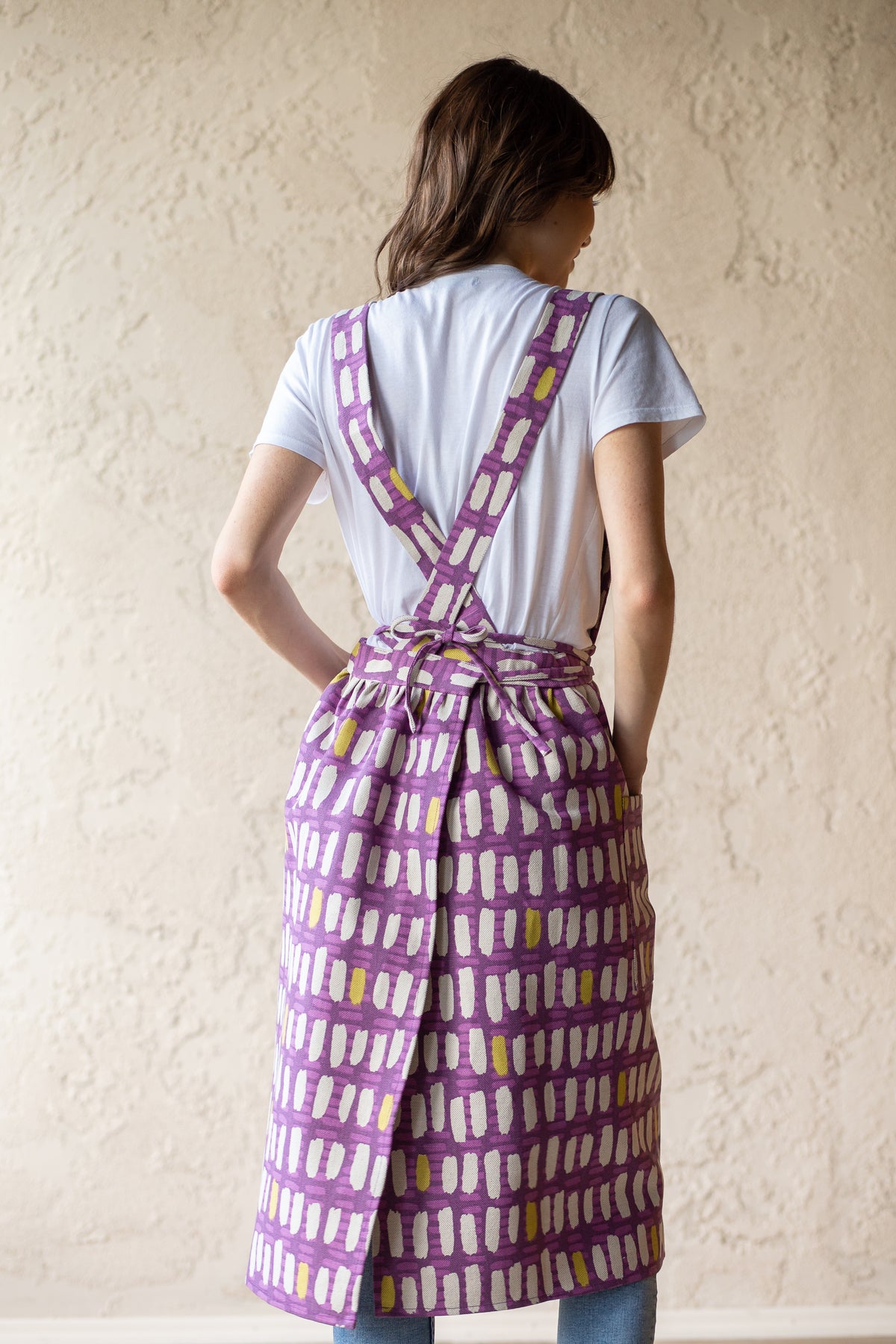 Cross back pinafore apron, worn while working