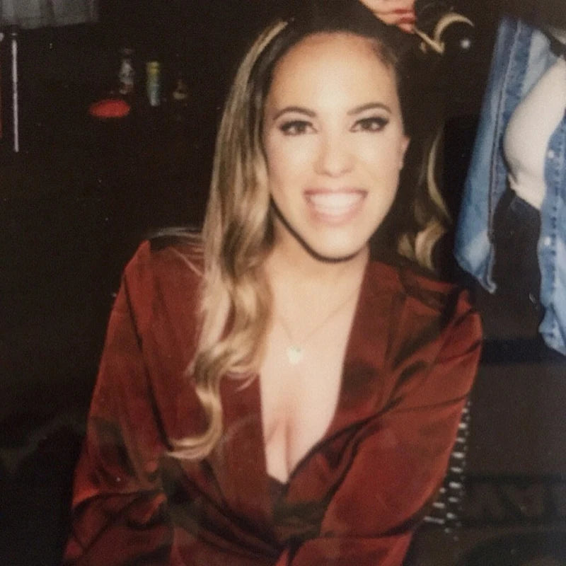 Customer photo, woman smiling in a burgundy satin robe