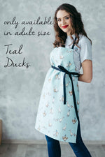 Yellow duck print kids apron, styled