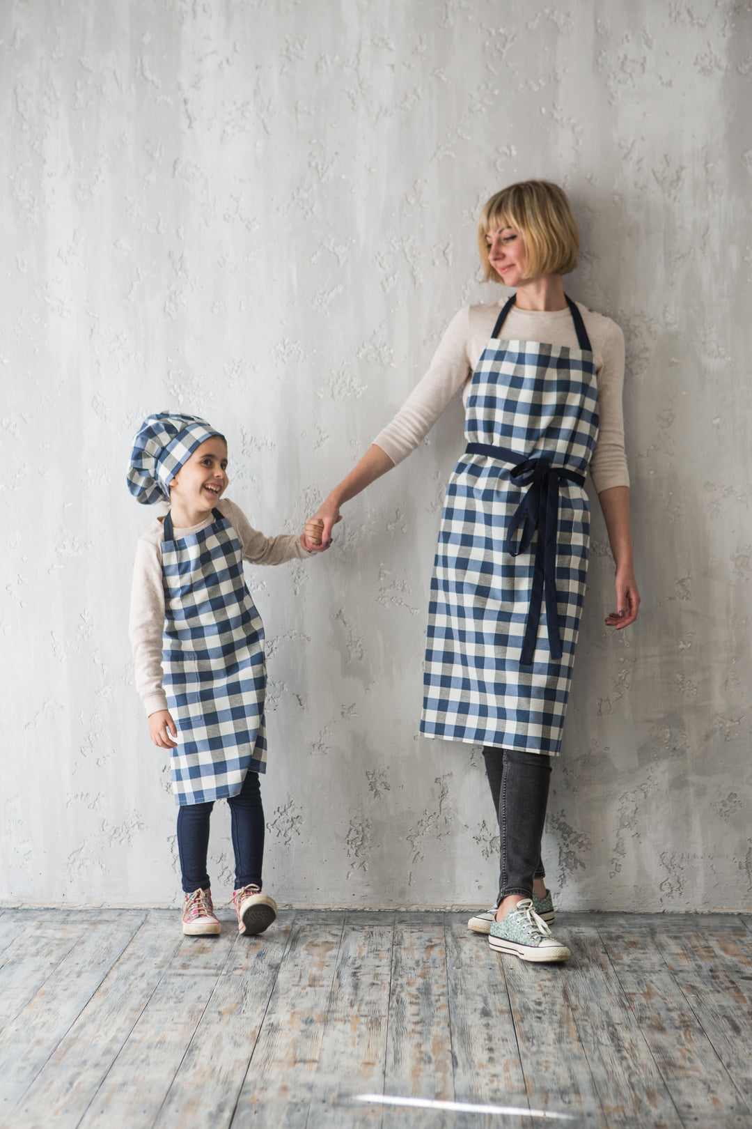 Matching gingham check aprons for mother and child