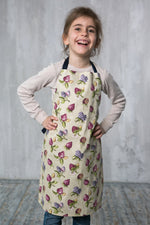 Strawberry print kids apron in beige, front view