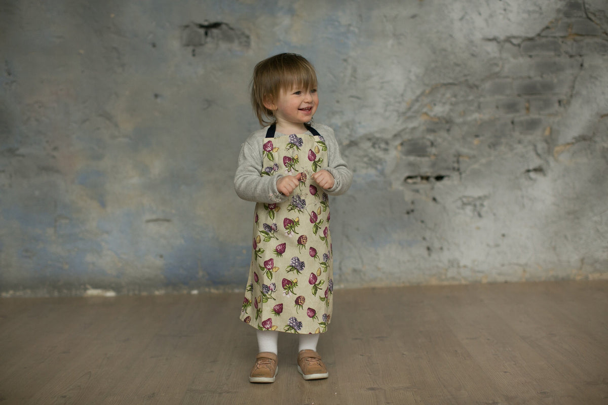 Matching adult and kids strawberry print aprons in beige and duck egg