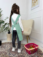 Green striped kids smock apron, cross back, front view