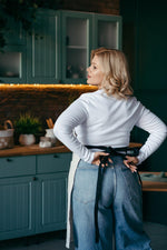 Black linen apron with pockets, full length view