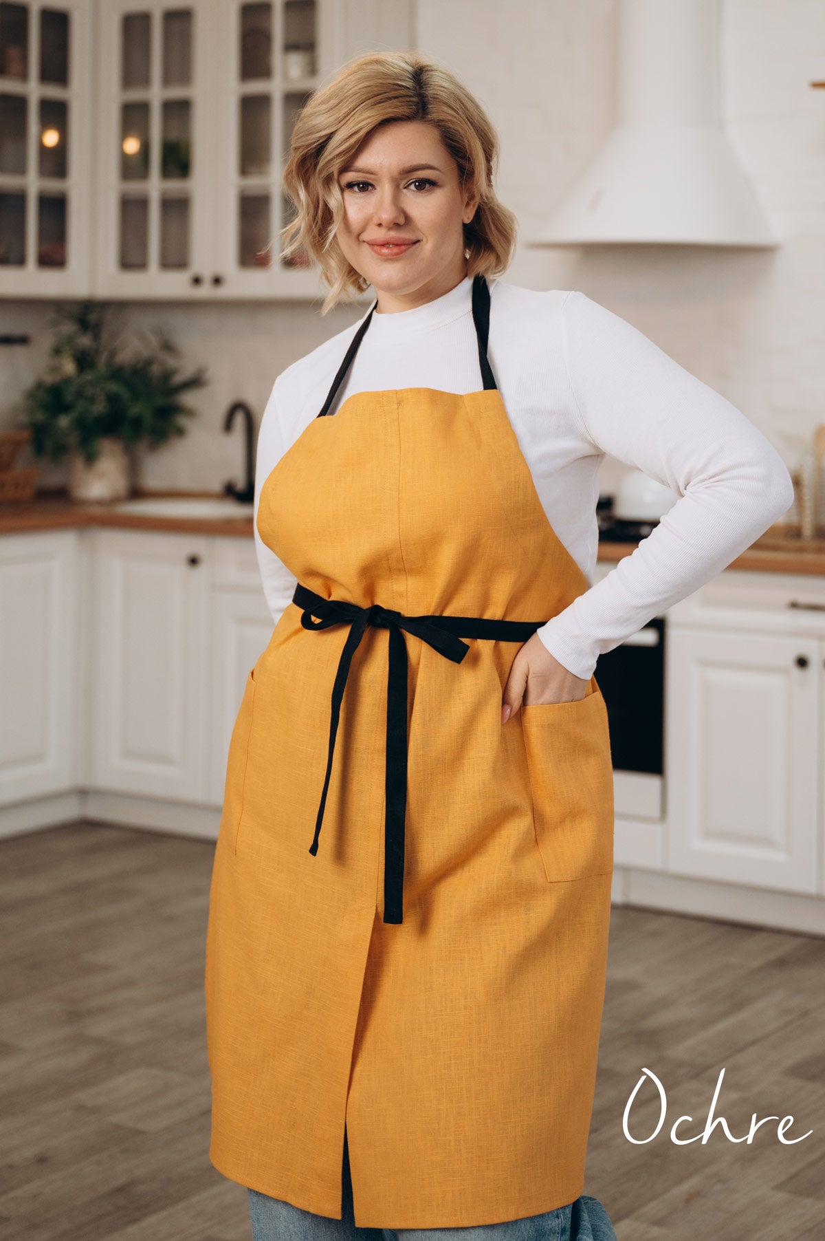 Ochre linen split leg apron, front view