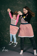 Matching lace aprons, mother and daughter styled