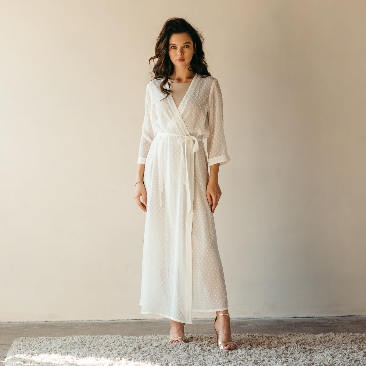 Ivory sheer robe worn as a dressing gown by the bride