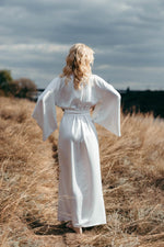 Black floral kimono styled with wide sleeves lifted