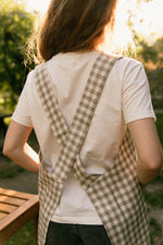 Checked linen pinafore apron, front view