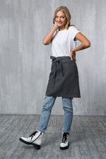 Grey linen waist apron worn by a waiter