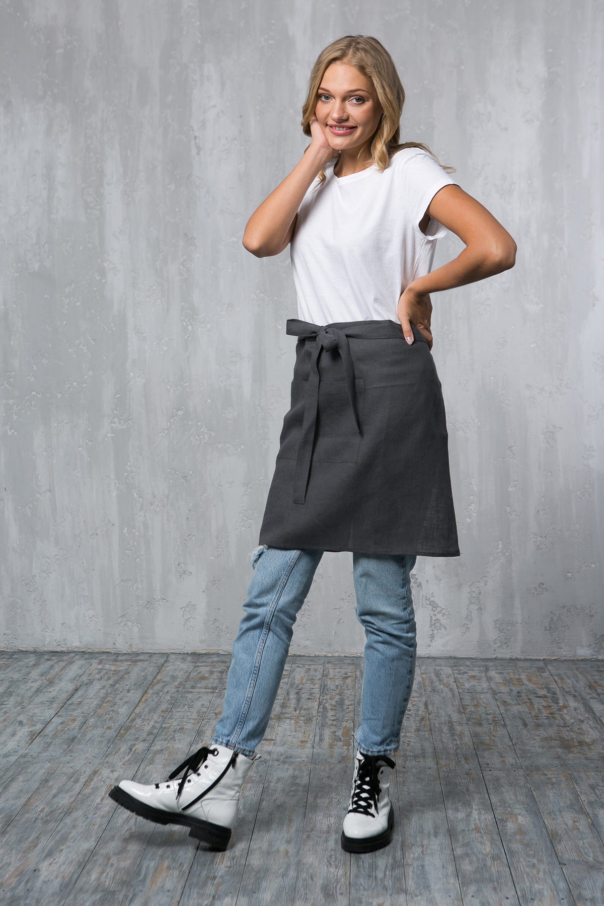 Grey linen waist apron worn by a waiter