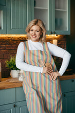 Rainbow linen pinafore apron with pockets, worn as an artist smock