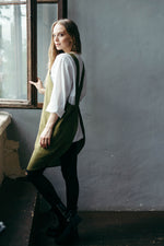 Short linen crossback apron, back view showing crossover straps
