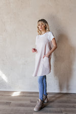 Short linen crossback apron worn by a florist