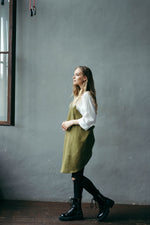Short linen crossback apron, rounded hem detail