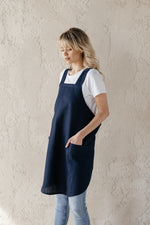 Short linen crossback apron, styled on model